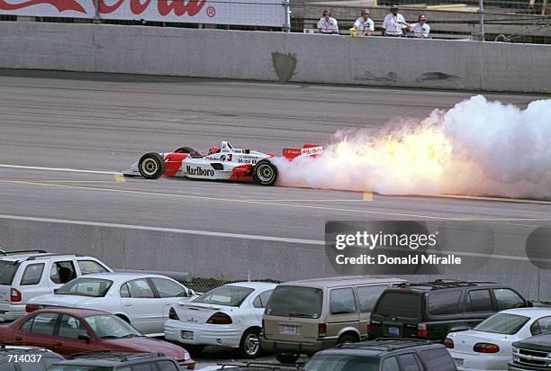 Driver Helio Castroneves of Brazil who drives the Honda Reynard 2KI for Marlboro Team Penske has an engine fire during the Target Grand Prix, part of...