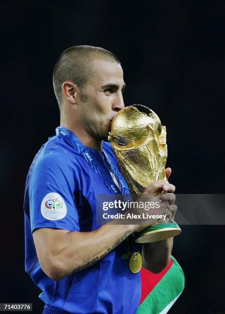 Fabio Cannavaro of Italy kisses the World Cup trophy following his team's victory in a penalty shootout at the end of the FIFA World Cup Germany 2006...