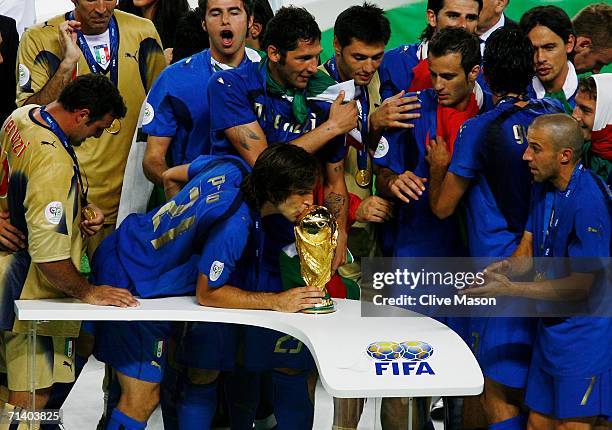 Andrea Pirlo of Italy kisses the World Cup trophy following his team's victory in a penalty shootout at the end of the FIFA World Cup Germany 2006...