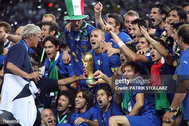 The Italian national football team celebrates with the 2006 World Cup trophy after they won their final football match against France at Berlin?s...