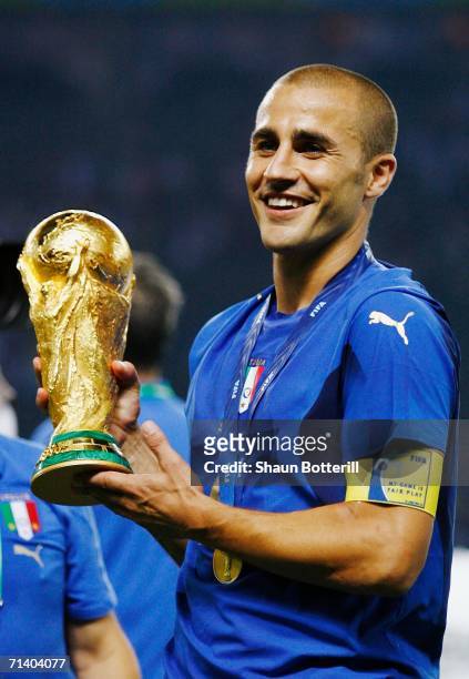 Fabio Cannavaro of Italy holds the World Cup trophy following his team's victory in a penalty shootout at the end of the FIFA World Cup Germany 2006...