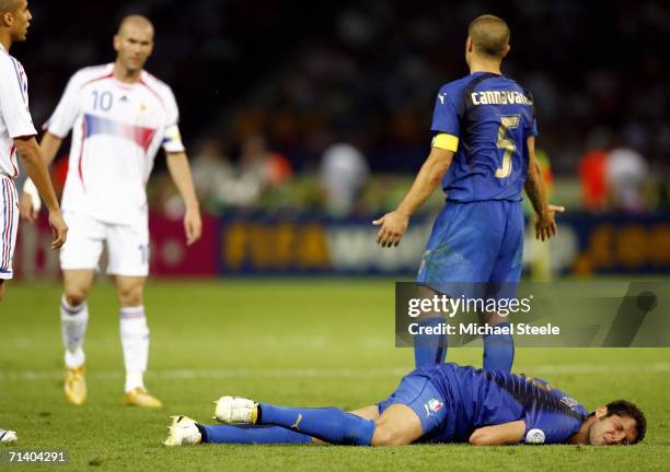 Fabio Cannavaro of Italy gestures towards Zinedine Zidane of France, whilst Marco Materazzi of Italy lies injured, after being headbutted in the...