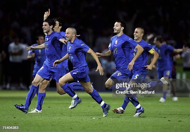 Italian players celebrate after teammate Fabio Grosso, scores the matchwinning penalty during the FIFA World Cup Germany 2006 Final match between...