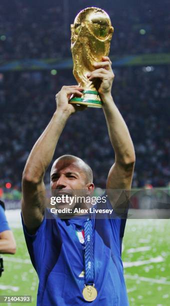 Alessandro Del Piero of Italy lifts the World Cup trophy aloft following his team's victory in a penalty shootout at the end of the FIFA World Cup...