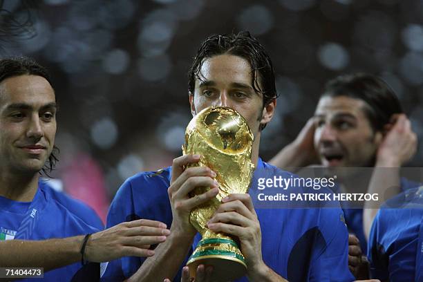 Italian defender Alessandro Nesta, Italian forward Luca Toni and Italian forward Vincenzo Iaquinta celebrate with the trophy after the World Cup 2006...