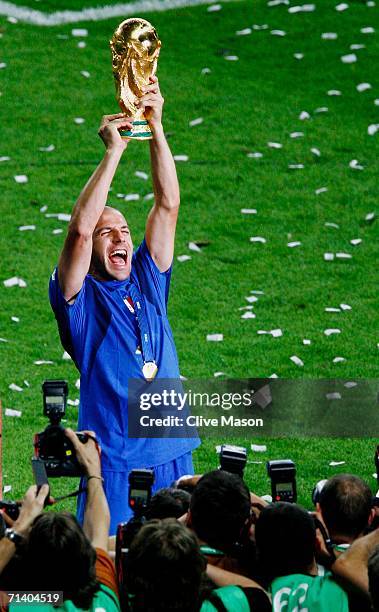 Alessandro Del Piero of Italy is surrounded by photographers as he holds the World Cup trophy aloft, following his team's victory in a penalty...