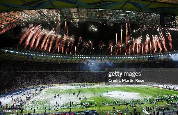 General view of a firework display as the Italian players and coaching staff celebrate with the World Cup trophy following their victory in a penalty...