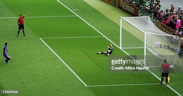 Fabio Grosso of Italy takes the matchwinning penalty, as Goalkeeper Fabien Barthez of France dives the wrong way during the FIFA World Cup Germany...