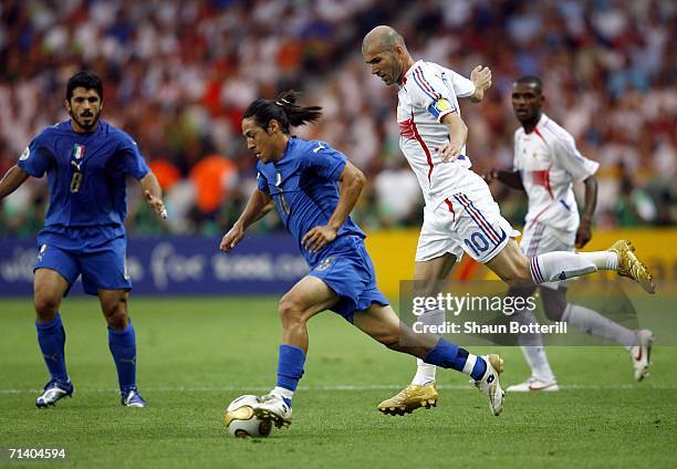 Mauro Camoranesi of Italy evades Zinedine Zidane of France during the FIFA World Cup Germany 2006 Final match between Italy and France at the Olympic...