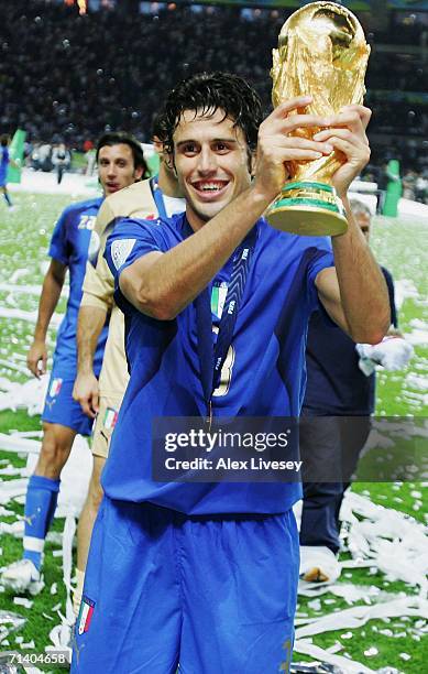 Fabio Grosso of Italy holds the World Cup trophy aloft following his team's victory in a penalty shootout at the end of the FIFA World Cup Germany...