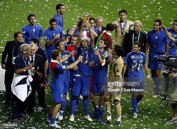 Marco Materazzi of Italy lifts the World Cup trophy aloft following victory at the end of the FIFA World Cup Germany 2006 Final match between Italy...