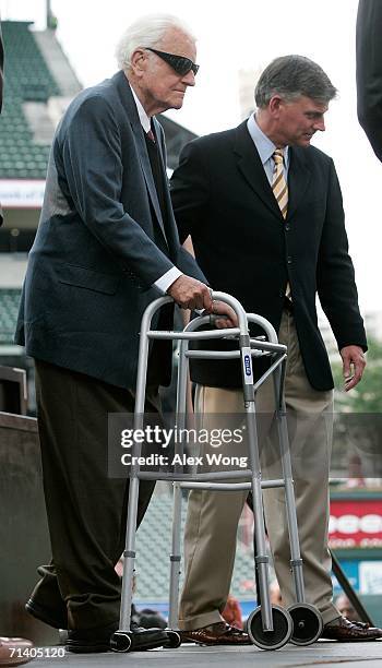 Franklin Graham assists his father evangelist Billy Graham to walk on the stage during the Metro Maryland 2006 Festival July 9, 2006 at Oriole Park...