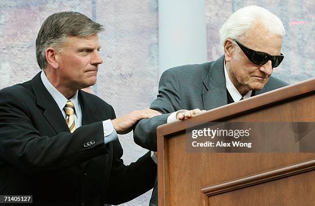 Franklin Graham assists his father evangelist Billy Graham to step onto the podium during the Metro Maryland 2006 Festival July 9, 2006 at Oriole...