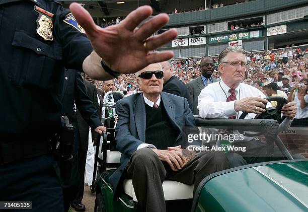 Police helps to clear a path for Billy Graham to pass through as he arrives to give the final message of the Metro Maryland 2006 Festival July 9,...