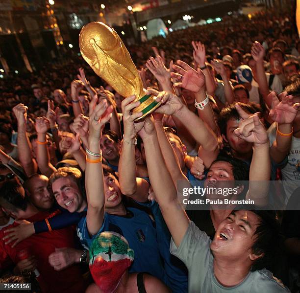 Thai soccer fans celebrate along side Italian tourists, after Italy won the penalty shoot out to win the World Cup July 10, 2006 in Bangkok,...