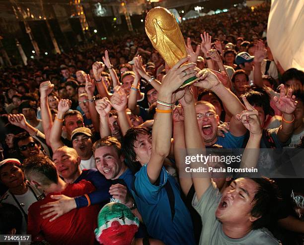 Thai soccer fans celebrate along side Italian tourists, after Italy won the penalty shoot out to win the World Cup July 10, 2006 in Bangkok,...