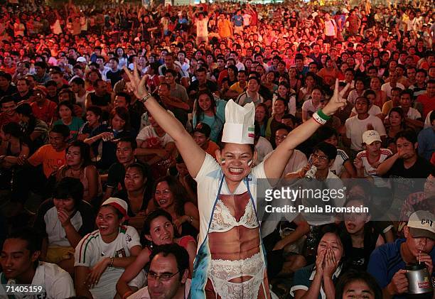 An Italy fan from Thailand cheers during the World Cup game July 10, 2006 in Bangkok, Thailand. Hundreds turned out in downtown Bangkok staying up...