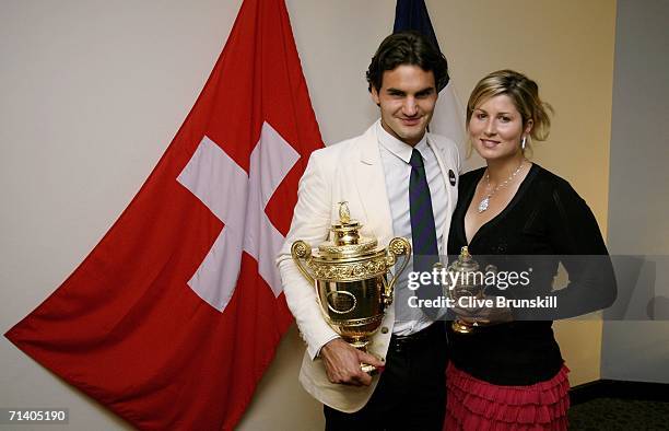 Wimbledon Mens Singles Champion Roger Federer of Switzerland poses with his trophy and girlfriend Mirka Vavrinec at the Wimbledon Winners' Dinner at...