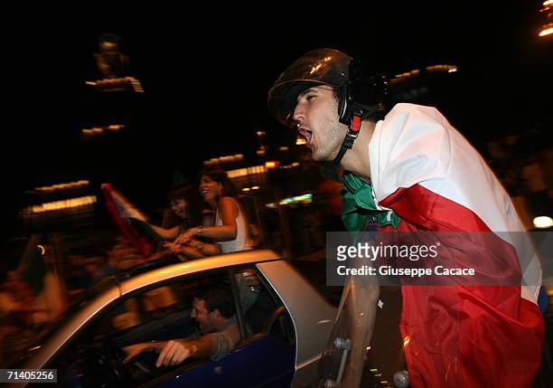 Italian football fans celebrate Italy's victory at the World Cup 2006 finals on July 9, 2006 in Milan, Italy. Italy defeated France at the World Cup...