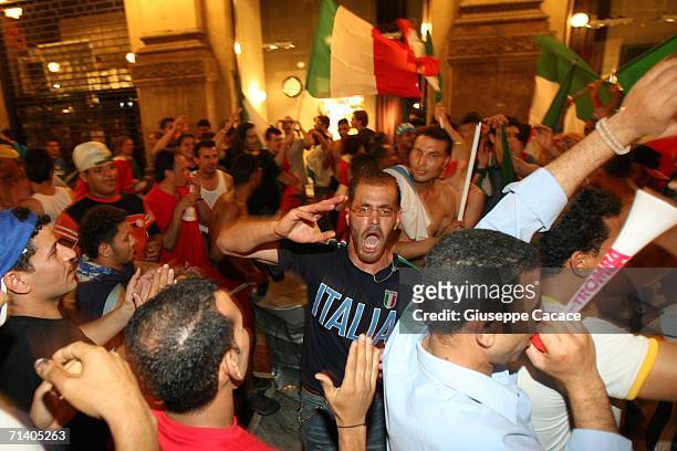Italian football fans celebrate Italy's victory at the World Cup 2006 finals in "Galleria Vittorio Emanuele" on July 9, 2006 in Milan, Italy. Italy...