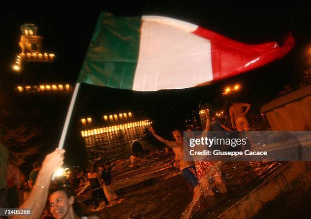 Italian football fans celebrate Italy's victory at the World Cup 2006 finals on July 9, 2006 in Milan, Italy. Italy defeated France at the World Cup...