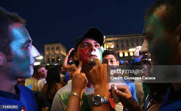 Italian football fans paint their faces during the World Cup Final in a public viewing area in ''Piazza del Duomo'' on July 9, 2006 in Milan, Italy....