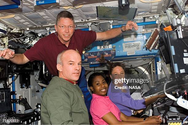 In this handout photo provided by NASA, astronaut Stephanie D. Wilson , STS-121 mission specialist, works with the Mobile Service System and...
