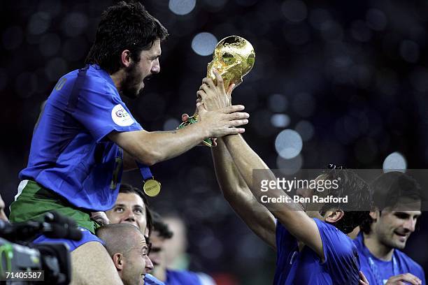 Gennaro Gattuso and Fabio Grosso of Italy celebrate with the world cup trophy during the FIFA World Cup Germany 2006 Final match between Italy and...