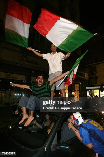 Italian football fans celebrate Italy's victory at the World Cup 2006 finals on July 9, 2006 in Milan, Italy. Italy defeated France at the World Cup...