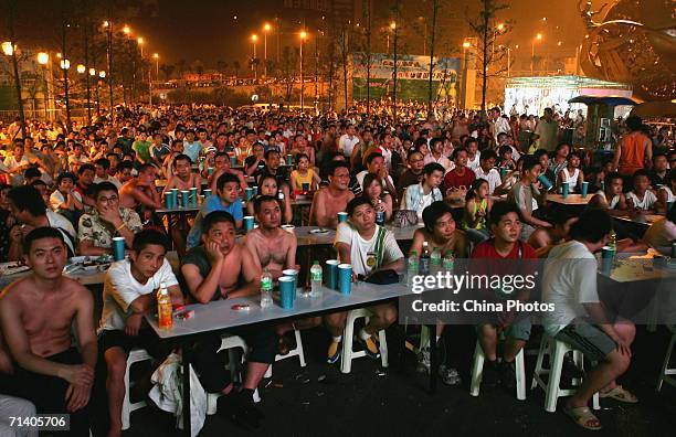 Football fans watch the World Cup final between Italy and France on an outdoor screen on July 10, 2006 in Chongqing Municipality, China. Italy went...