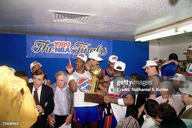 John Salley of the Detroit Pistons celebrates with the NBA Championship trophy after winning the 1989 NBA Title by defeating the Los Angeles Lakers...