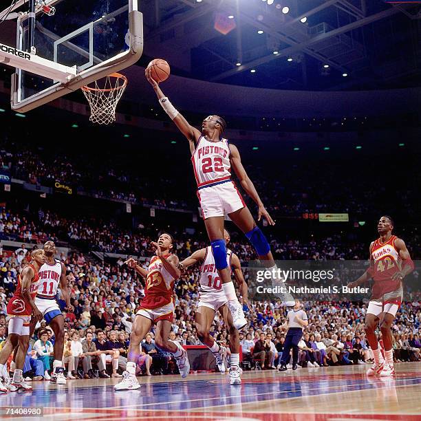 John Salley of the Detroit Pistons attempts a layup against the Atlanta Hawks during an NBA game played at the Palace of Auburn Hills in Detroit,...