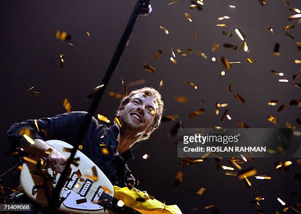 Singer Chris Martin of the Coldplay band performs at the Singapore Indoor Stadium, 10 July 2006. The internationally-acclaimed British music group...