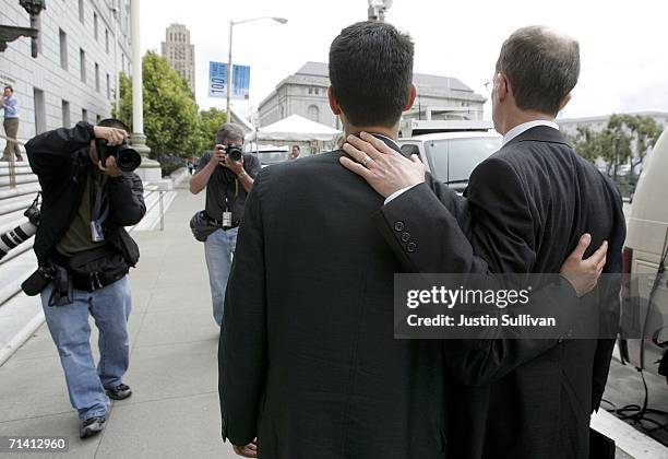 News photographers take photographs of Stewart Gaffney and his gay partner John Lewis as they take a break from a hearing at the California state...