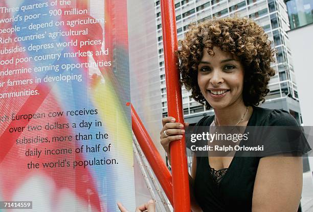 German singer Joy Delanane, ambassadress for the United nations "UN-Milenium-Campaign", poses next to a poster in front of the German United Nations...