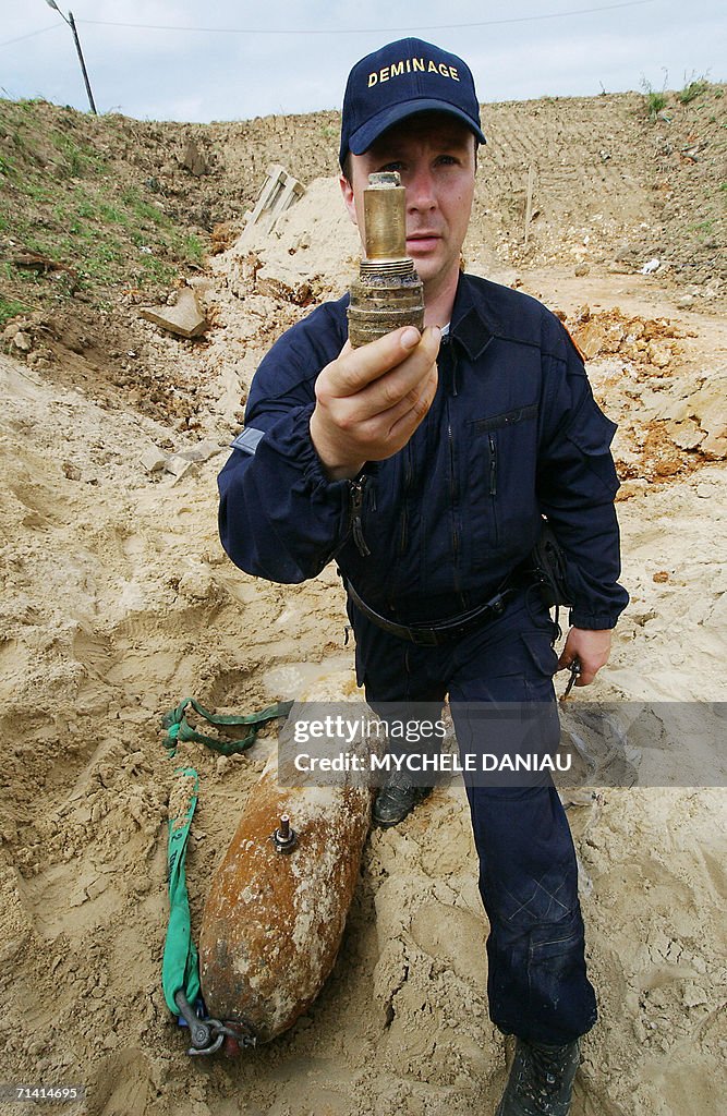 A mine-clearing expert shows a detonator