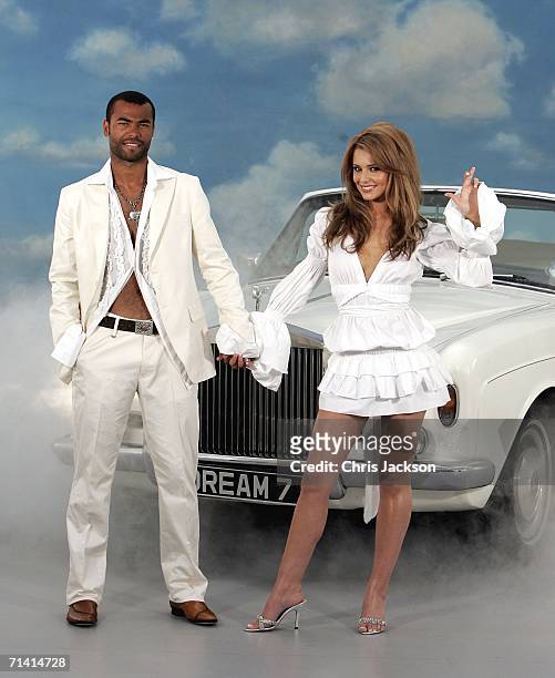 Singer Cheryl Tweedy of Girls Aloud and Footballer Ashley Cole pose in front of a Rolls Royce as they promote National Lottery's new Dream Number in...
