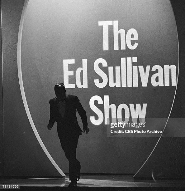 American variety show host Ed Sullivan makes his entrance, from the shadows, to the stage of his CBS program, 'The Ed Sullivan Show,' New York,...