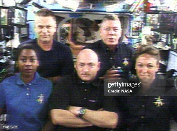 In this handout photo provided by NASA, Astronauts Stephanie Wilson, Piers Sellers, Mark Kelly, Mike Fossum and Lisa Nowak answer questions from...