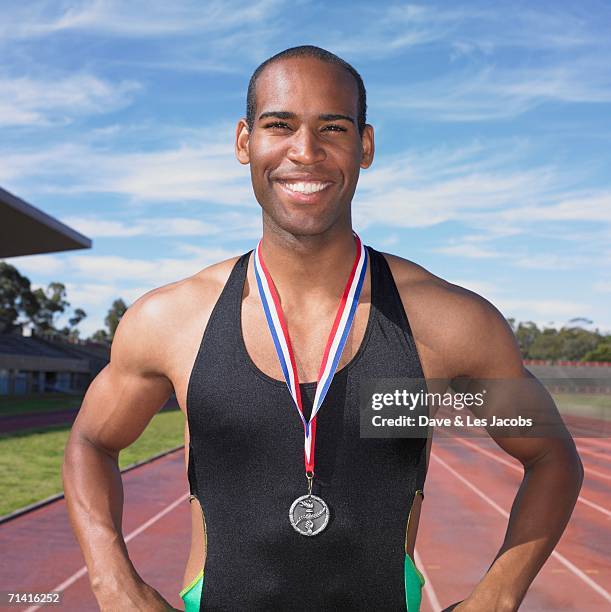 african male athlete with medal - medalist stock pictures, royalty-free photos & images