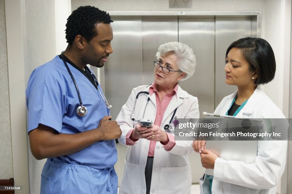 Hospital staff talking in front of elevator