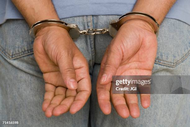 close up of male hands in handcuffs - parte inferior imagens e fotografias de stock