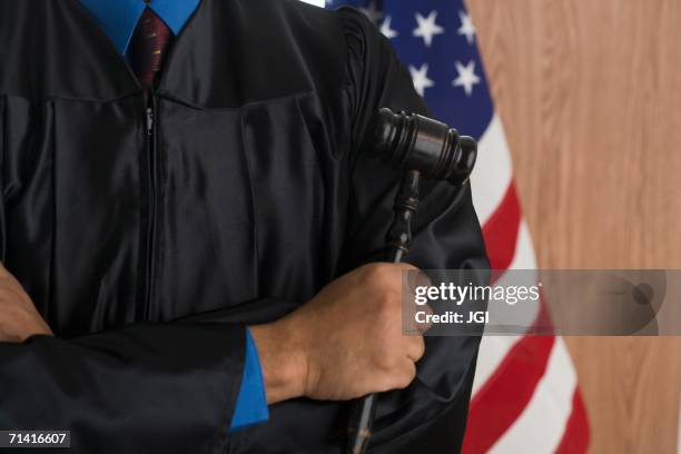 close of african male judge holding gavel - judges robe stock pictures, royalty-free photos & images