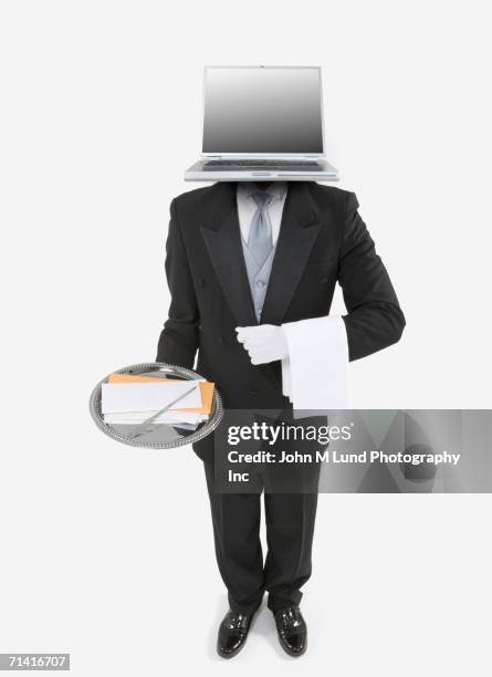 butler with a laptop for a head holding a silver tray with mail - abrecartas fotografías e imágenes de stock