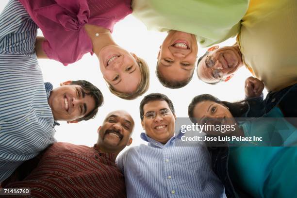 low angle studio shot of people in a huddle - honduras people stock pictures, royalty-free photos & images