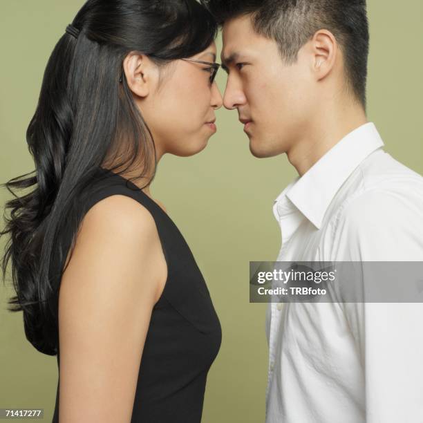 studio shot of asian couple head to head - scrittura coreana foto e immagini stock