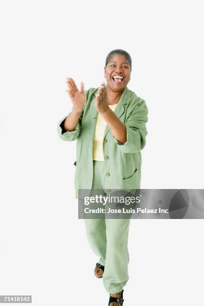 studio shot of senior african woman smiling and clapping - clapping hands white background stock pictures, royalty-free photos & images