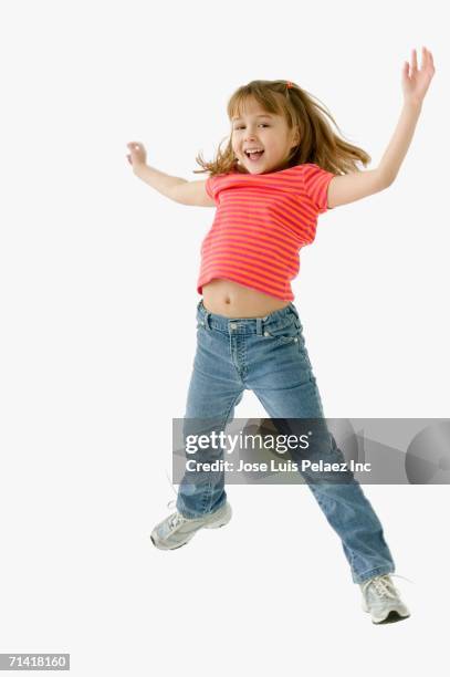 studio shot of young girl jumping - girls on white background stock pictures, royalty-free photos & images