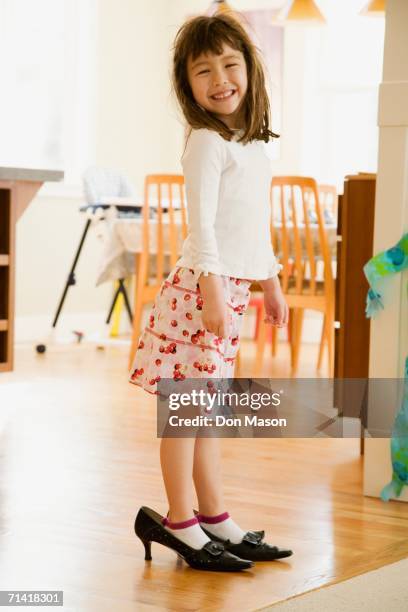 young girl wearing mother's shoes - child high heels stock pictures, royalty-free photos & images