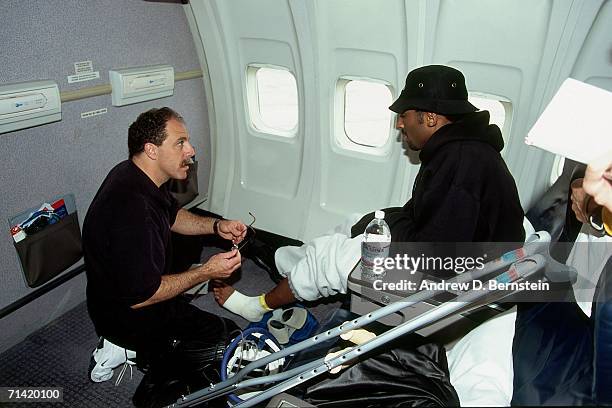 Kobe Bryant of the Los Angeles Lakers receieves treatment on board the team flight to Indiana the day before taking on Indiana Pacers in Game Three...